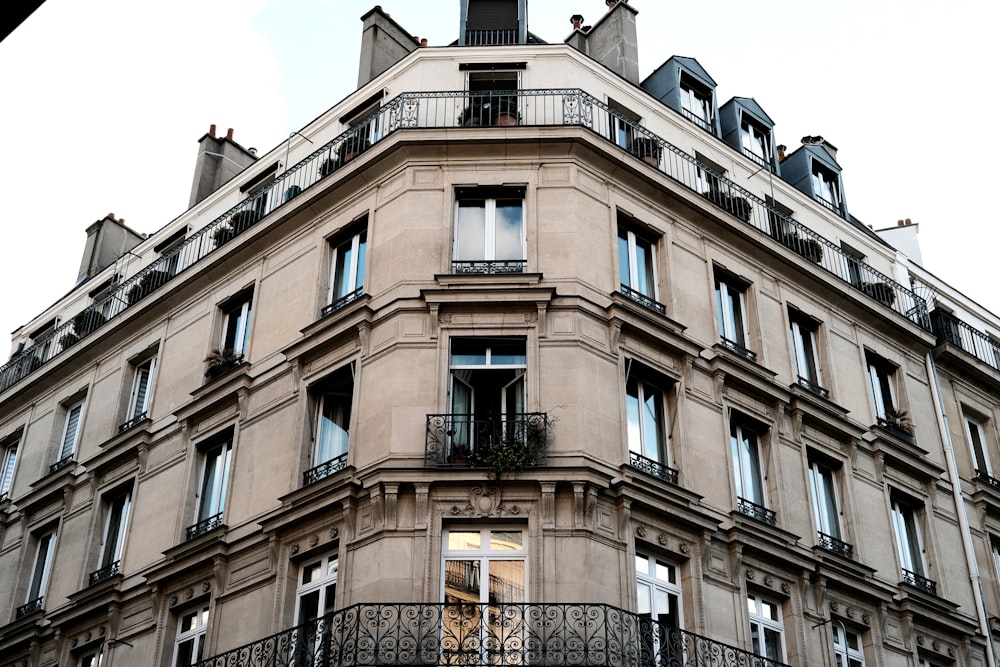 a tall building with lots of windows and balconies