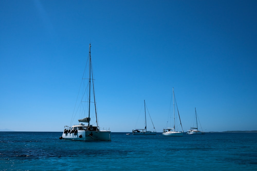 a group of boats floating on top of a body of water