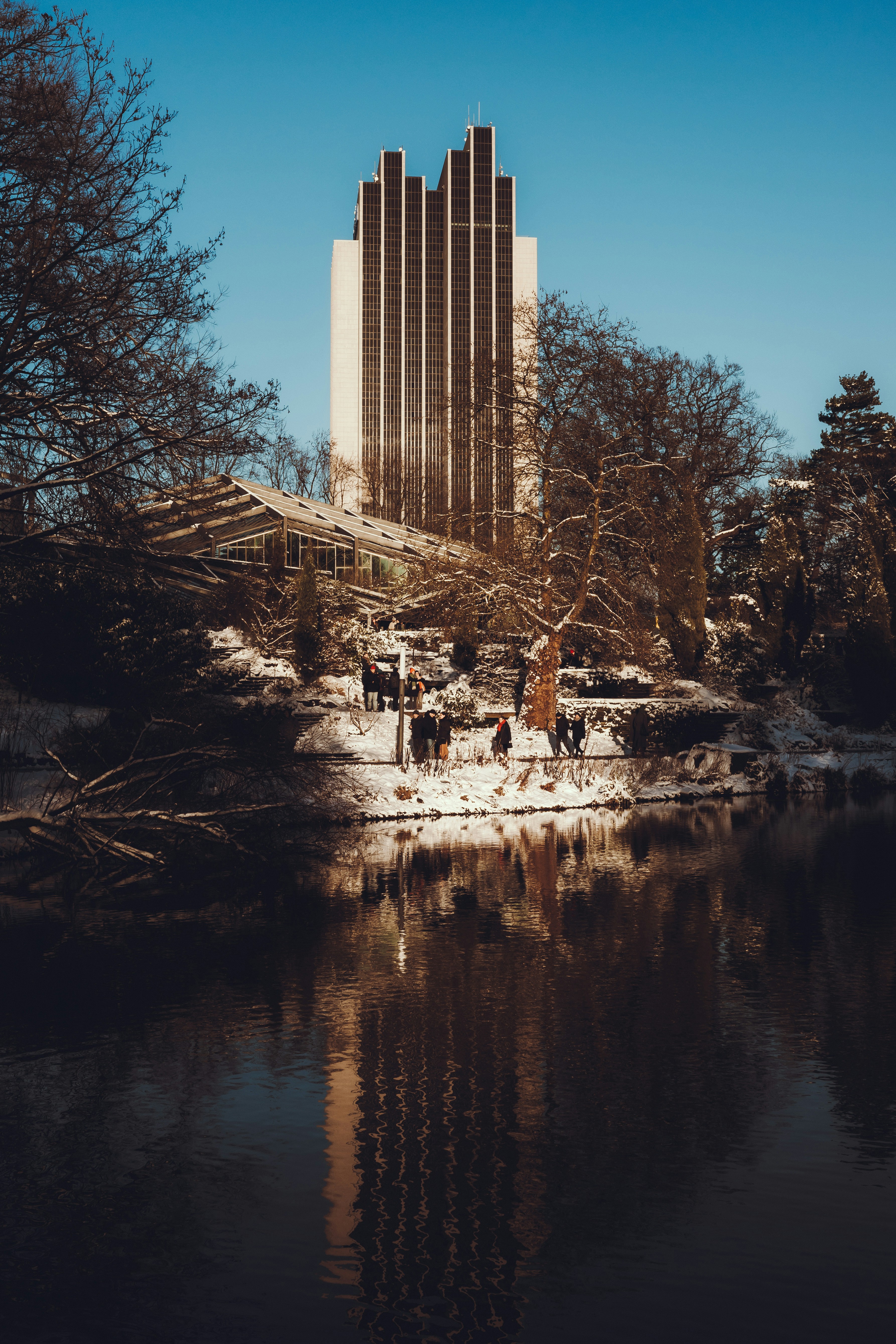 a tall building next to a body of water