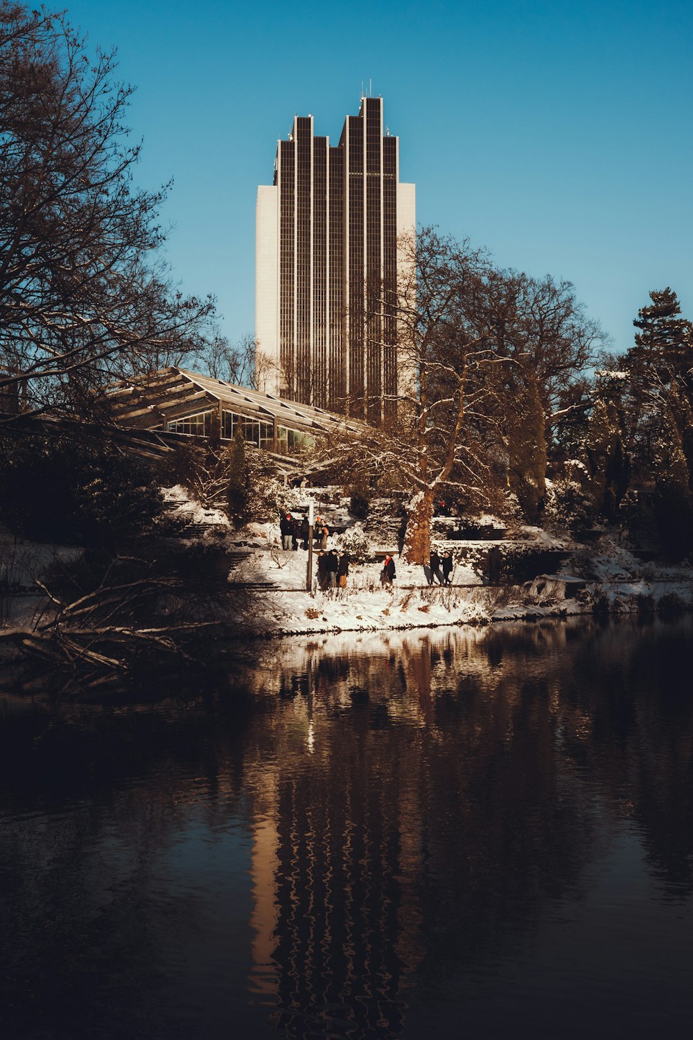 a tall building next to a body of water