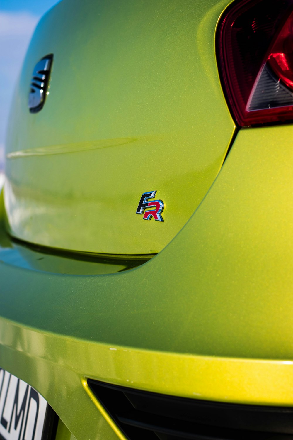 a close up of the tail end of a green sports car