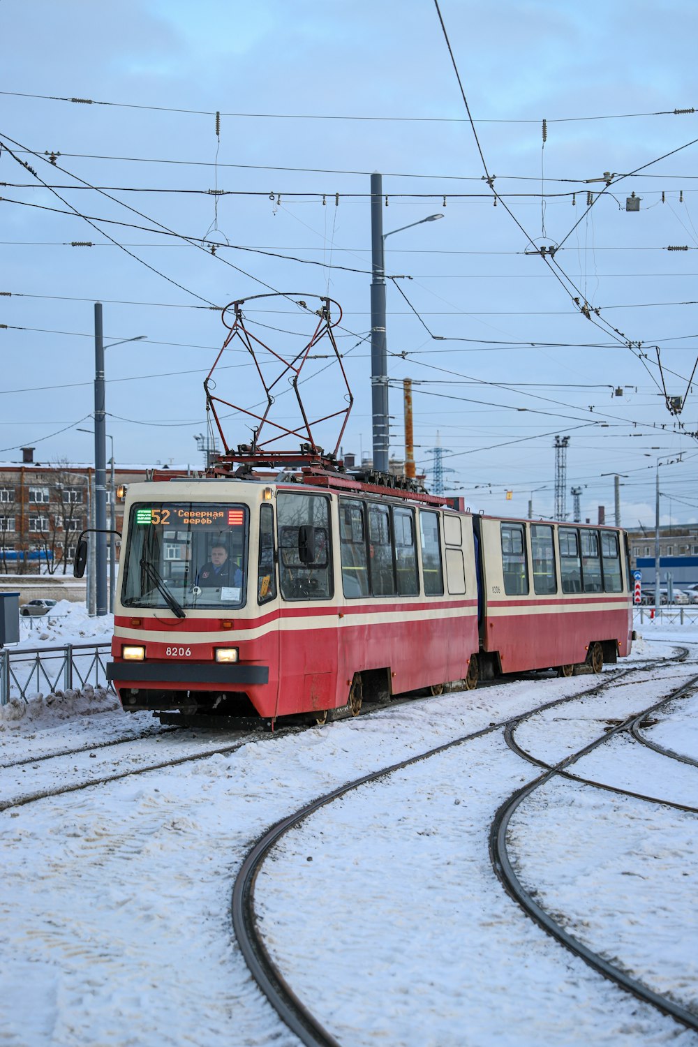 a red and white train traveling down train tracks