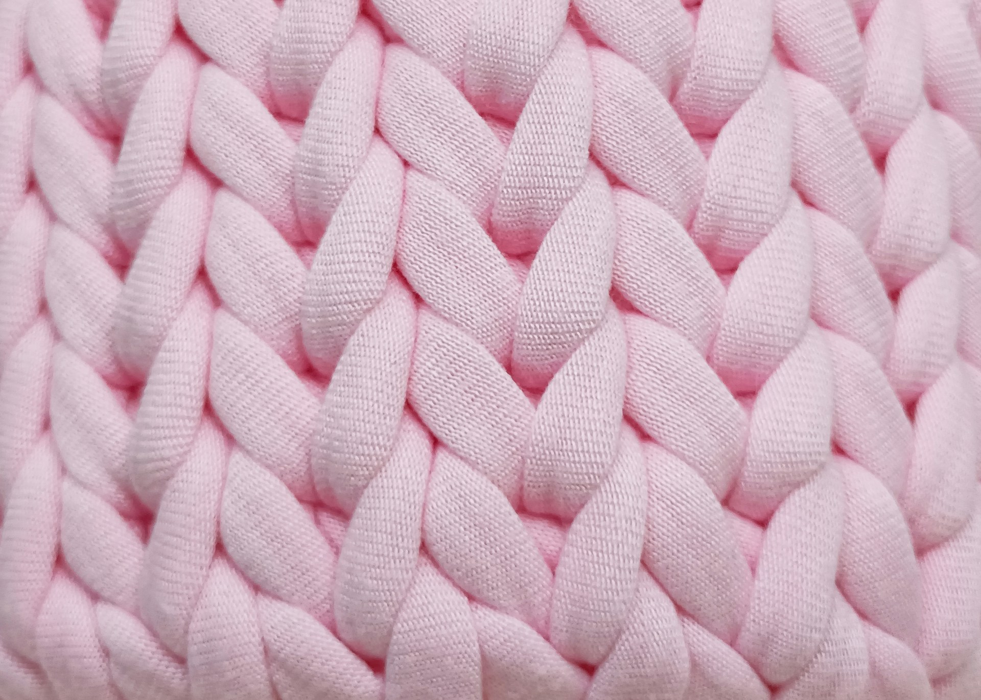 a close up of a pink knitted blanket
