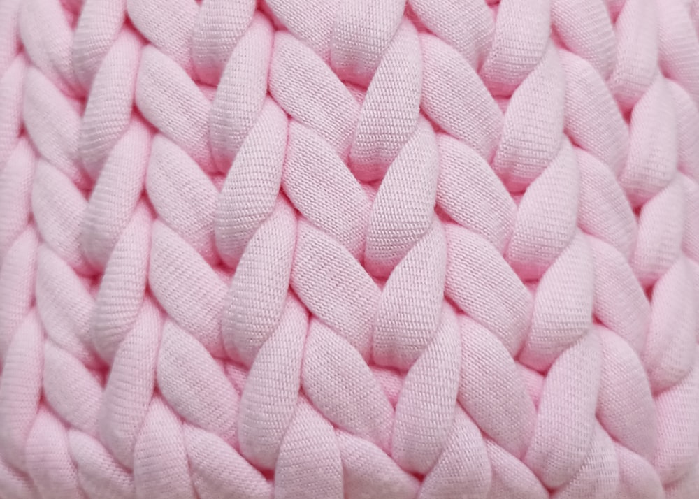 a close up of a pink knitted blanket