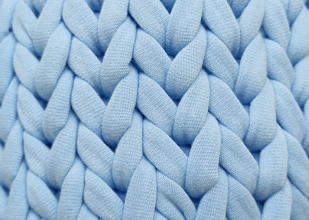 a close up of a blue knitted material