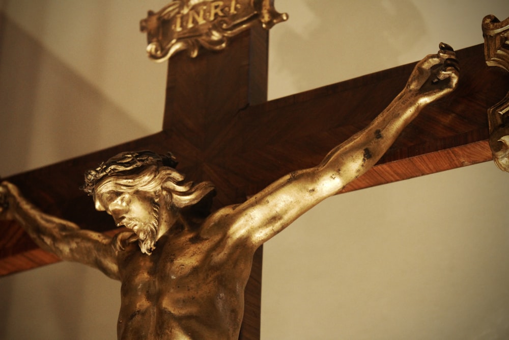 a statue of jesus on a wooden cross