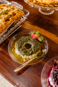 a wooden table topped with plates of food