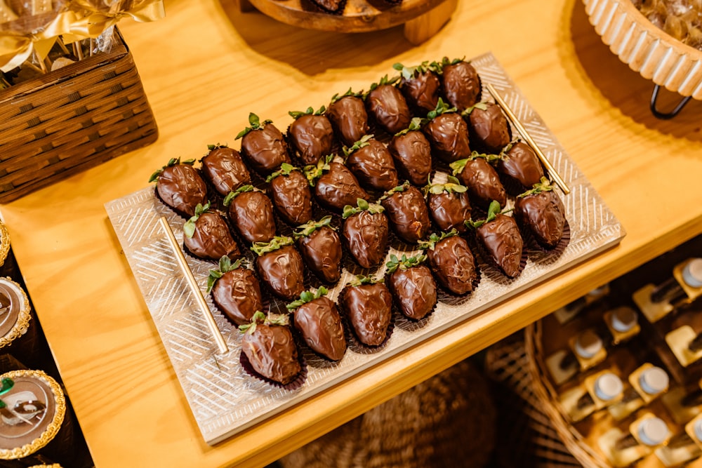 a tray of chocolate covered pastries on a table