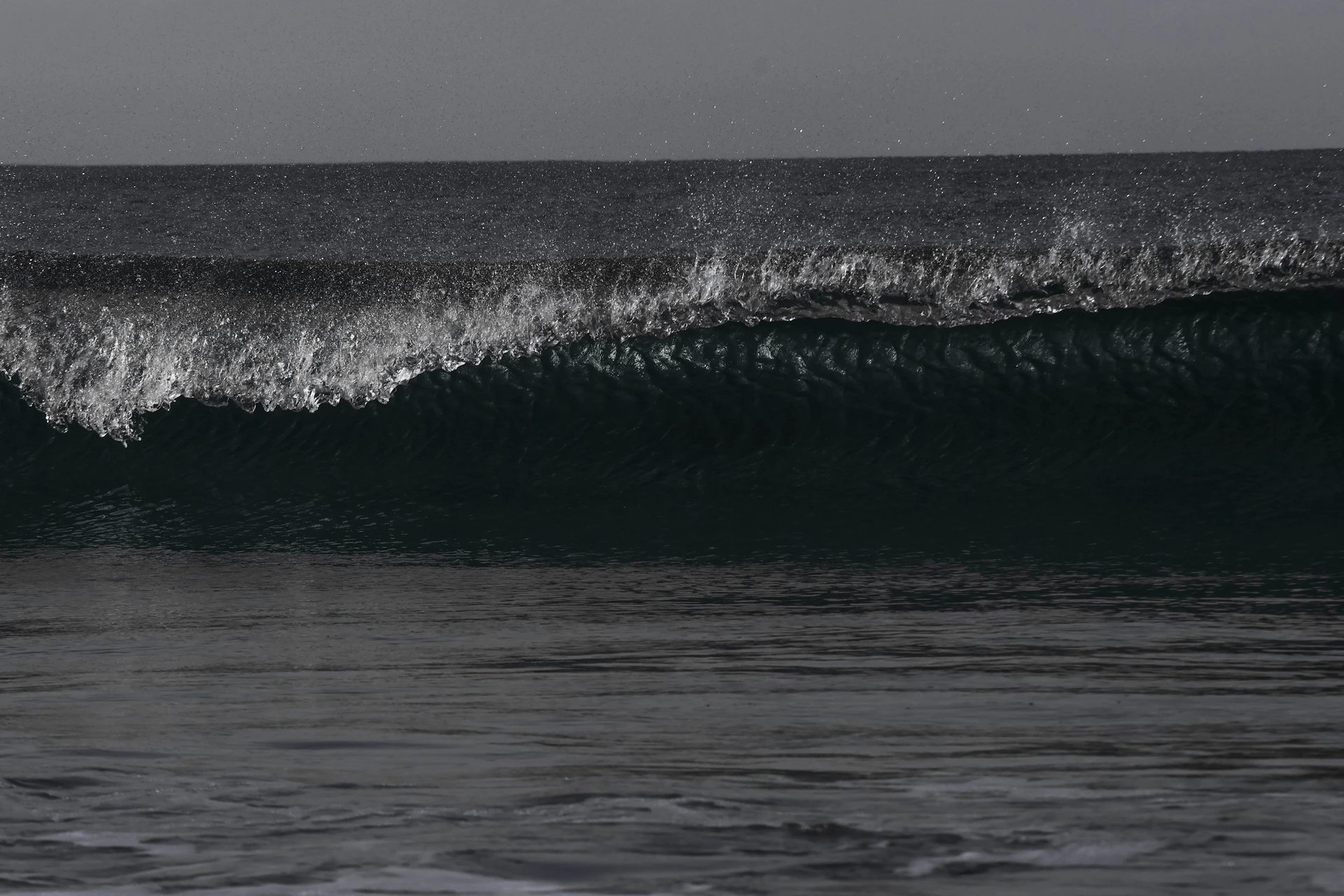 a man riding a wave on top of a surfboard