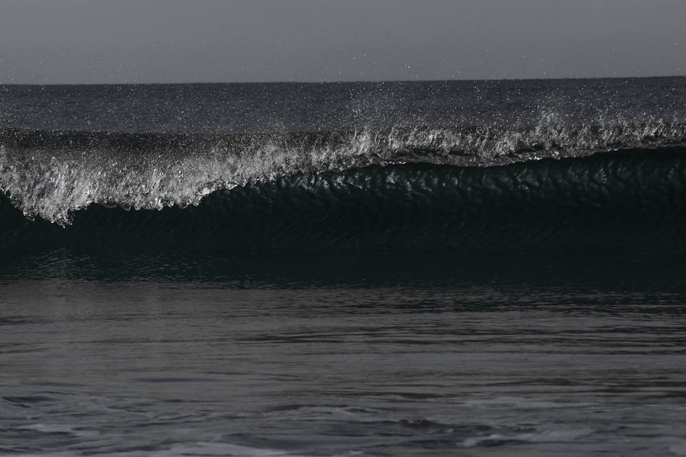 a man riding a wave on top of a surfboard