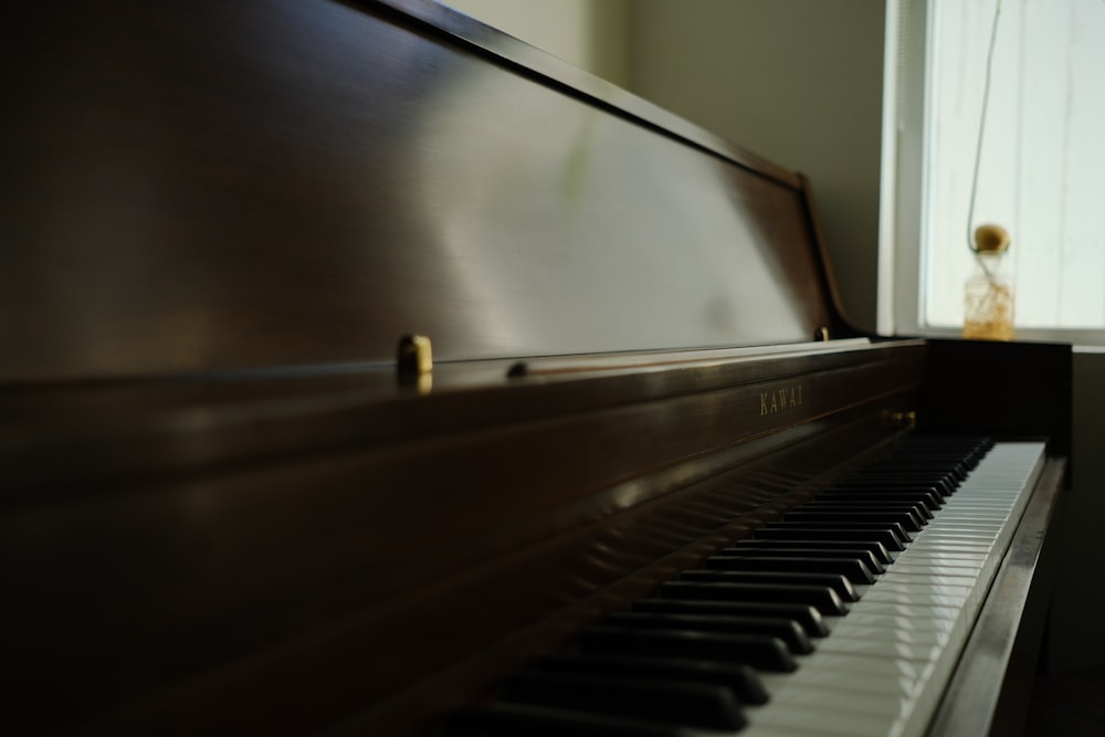 a close up of a piano near a window