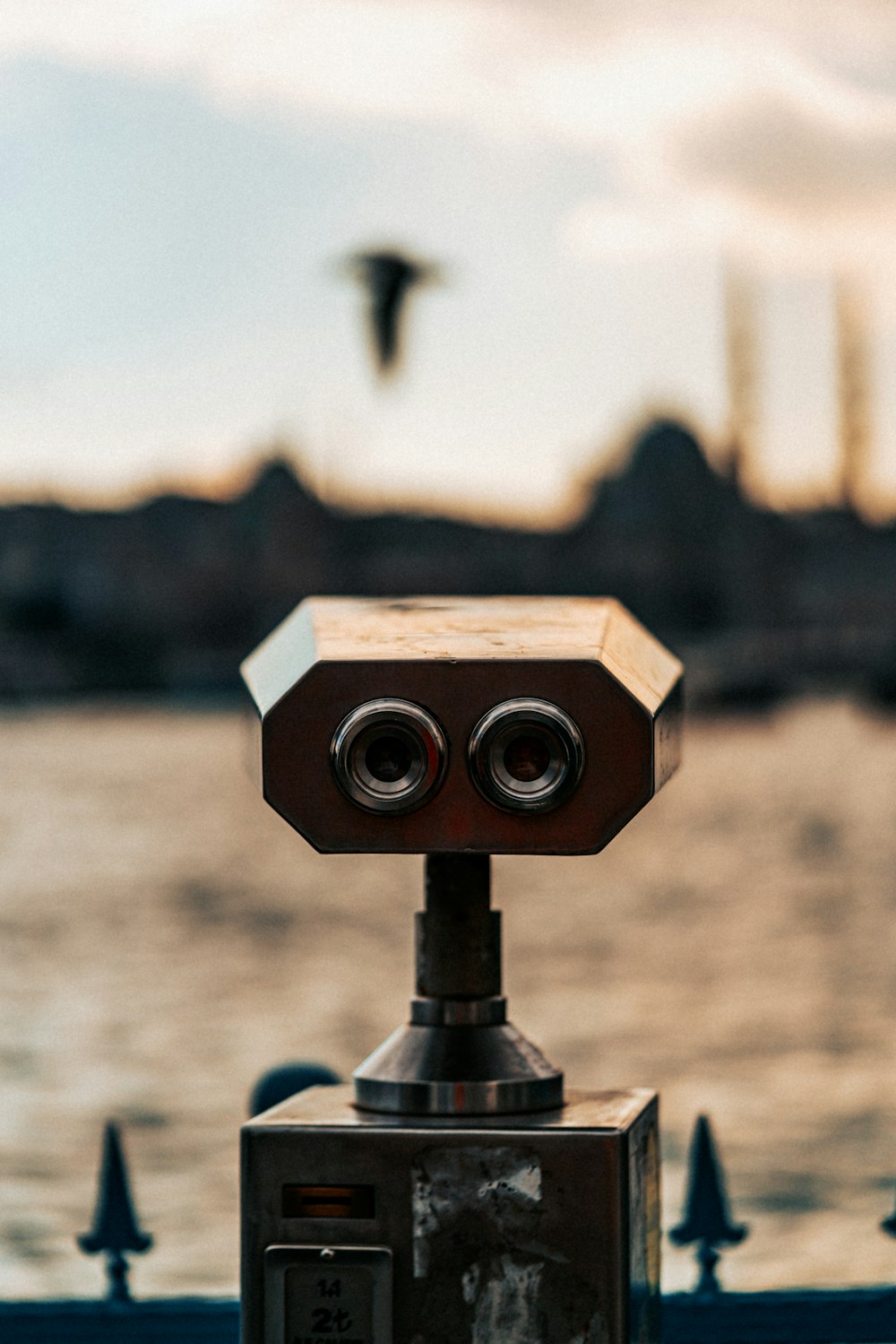 a close up of a camera with a body of water in the background