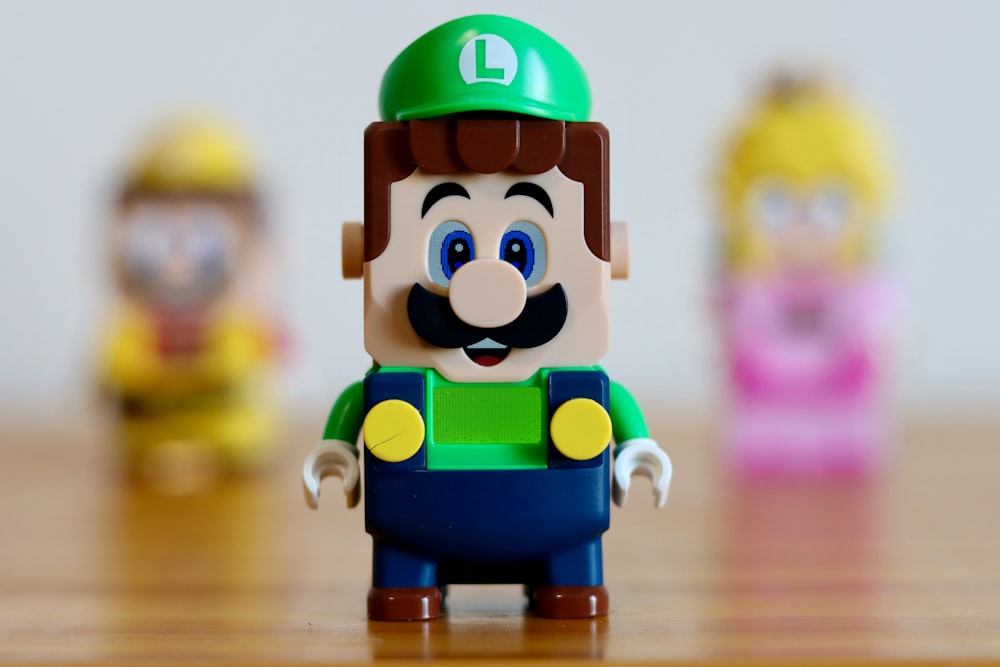 a toy figure of a man with a green hat