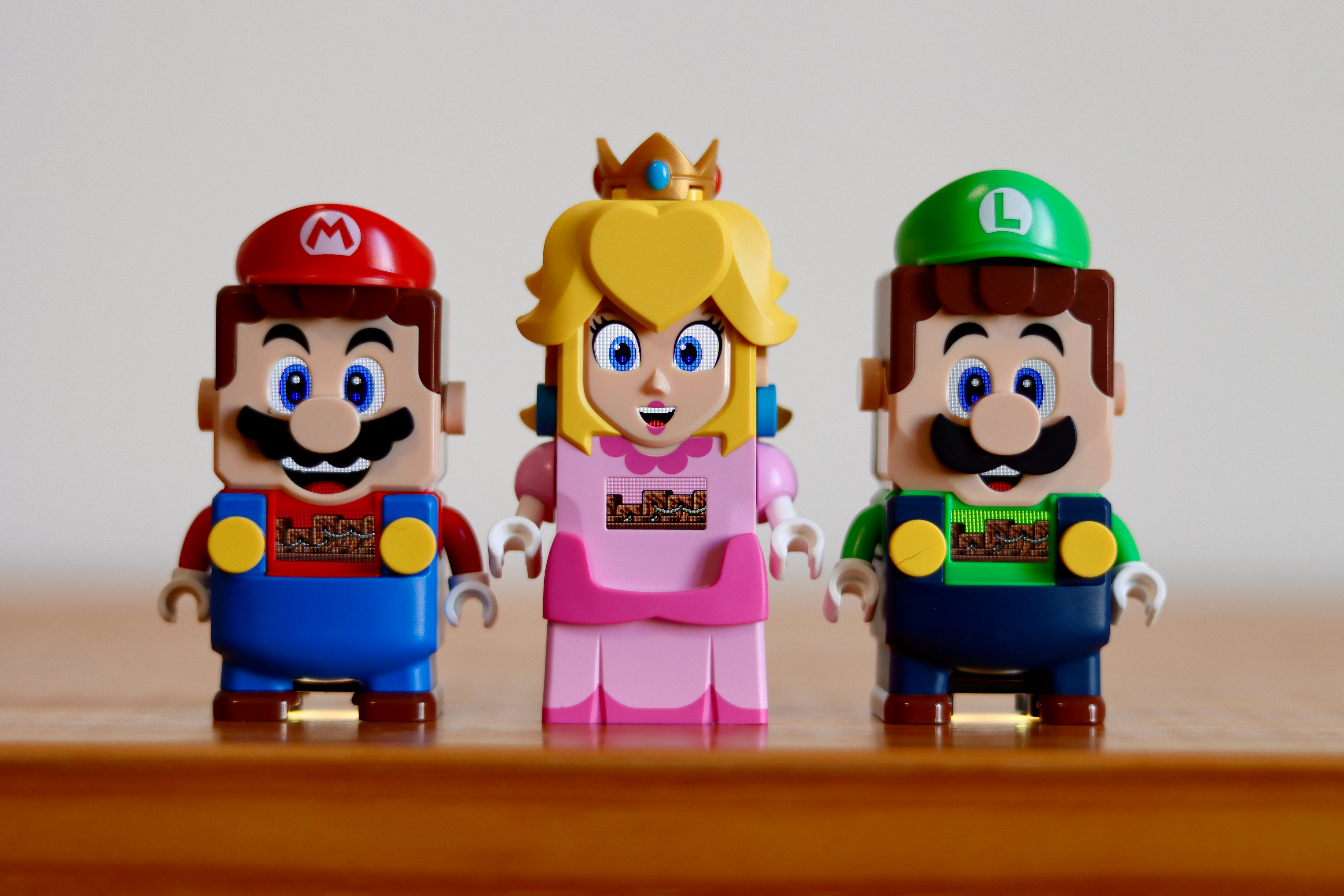 a group of toy figurines sitting on top of a wooden table