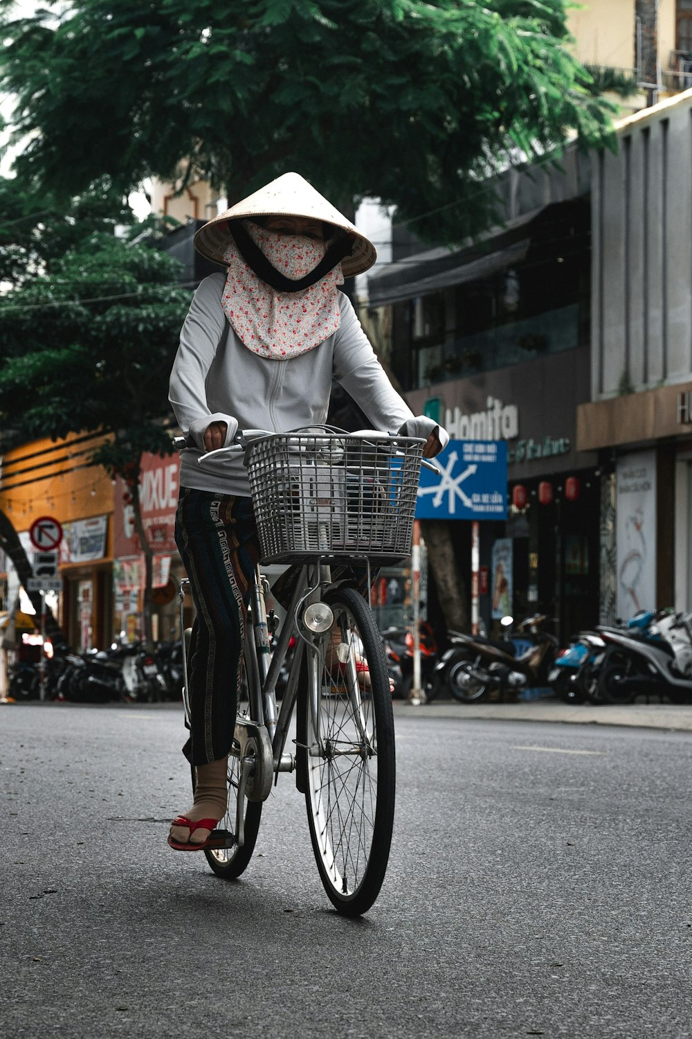 a woman riding a bike down a street