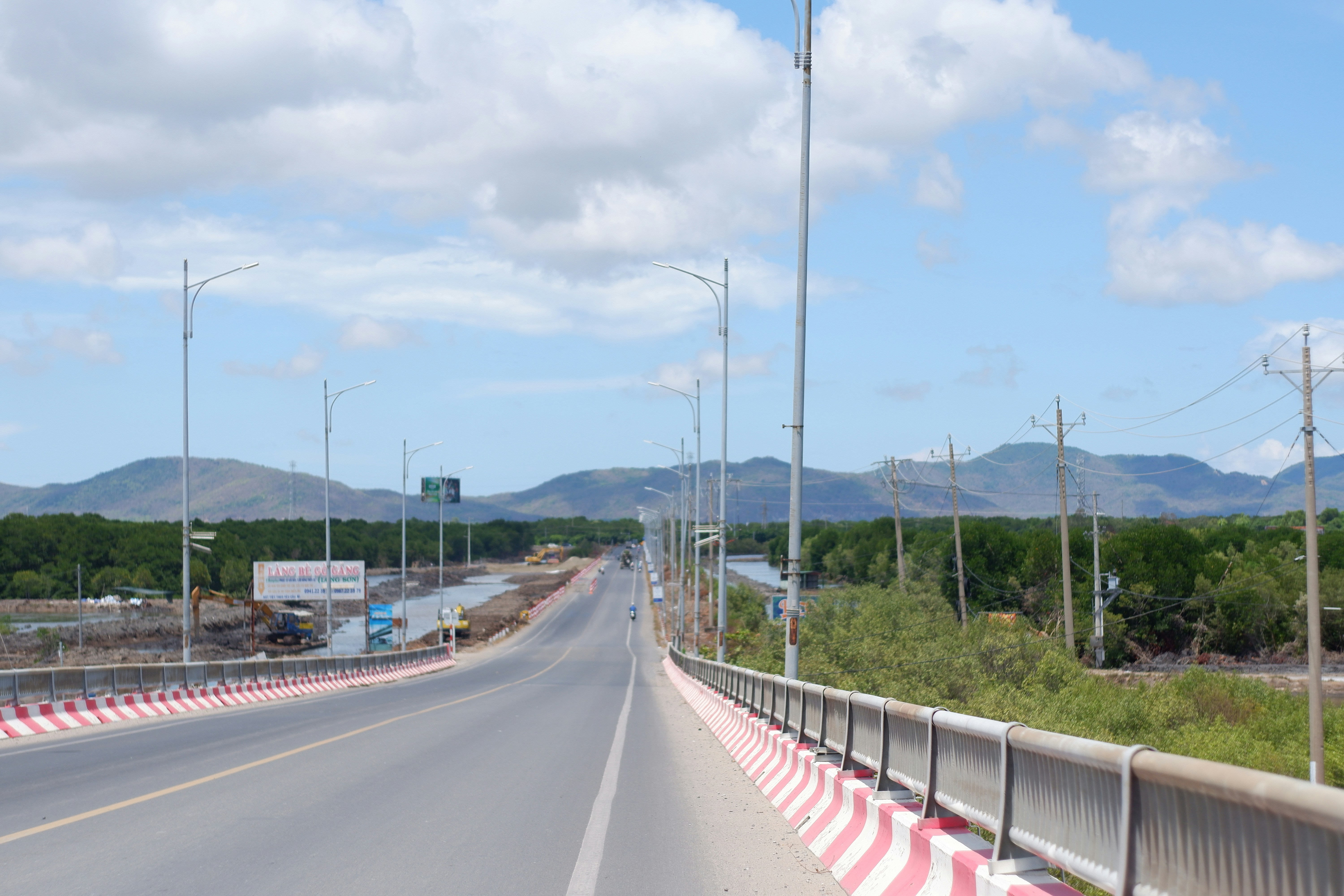 a road with a red and white barrier on the side of it