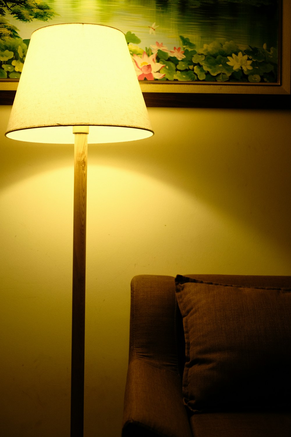 a lamp sitting on top of a table next to a couch