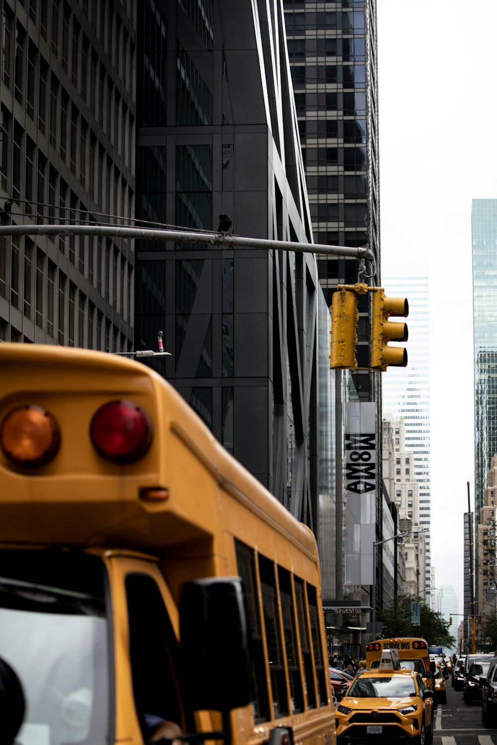 a city street filled with traffic next to tall buildings