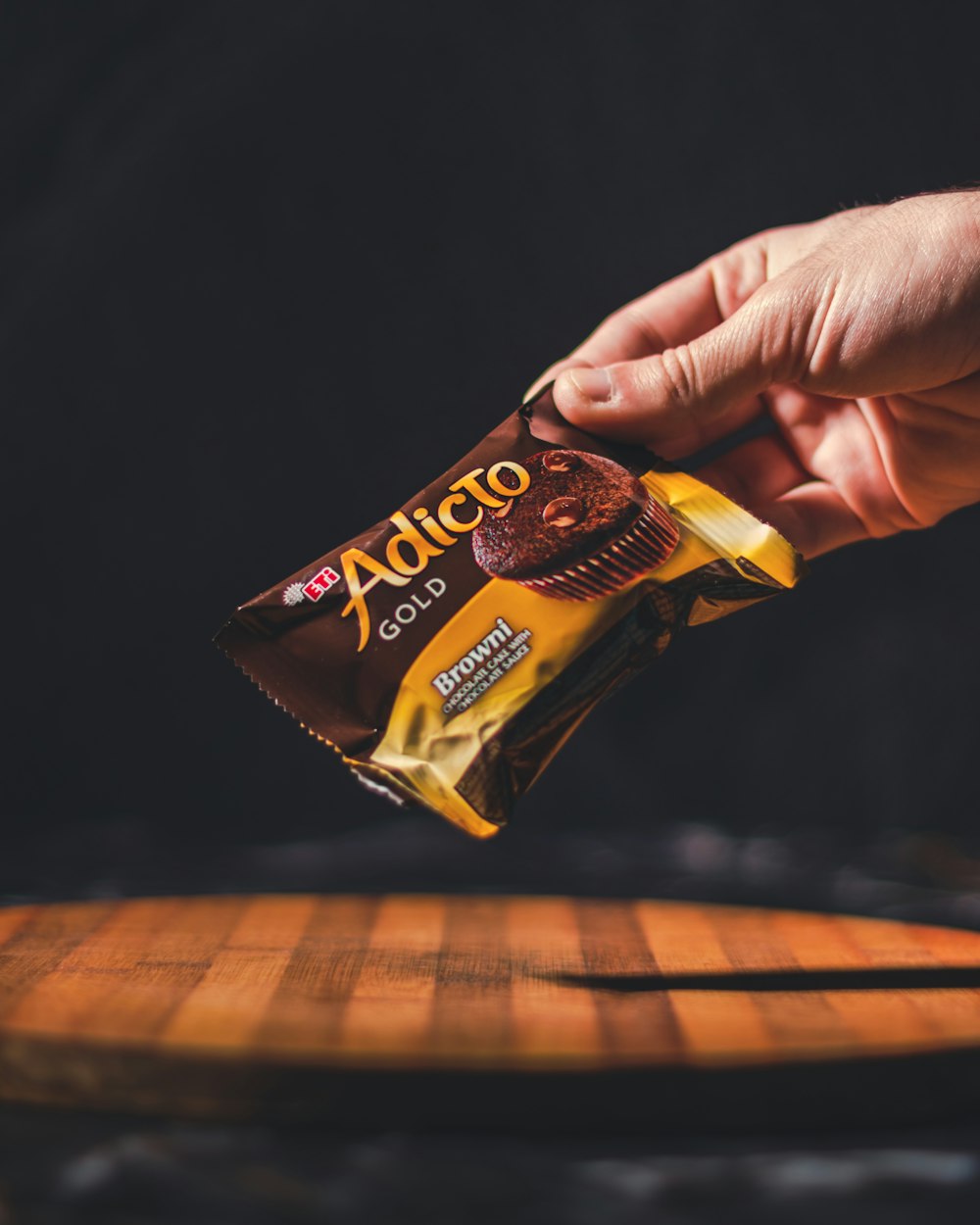 a person holding a bar of chocolate in their hand