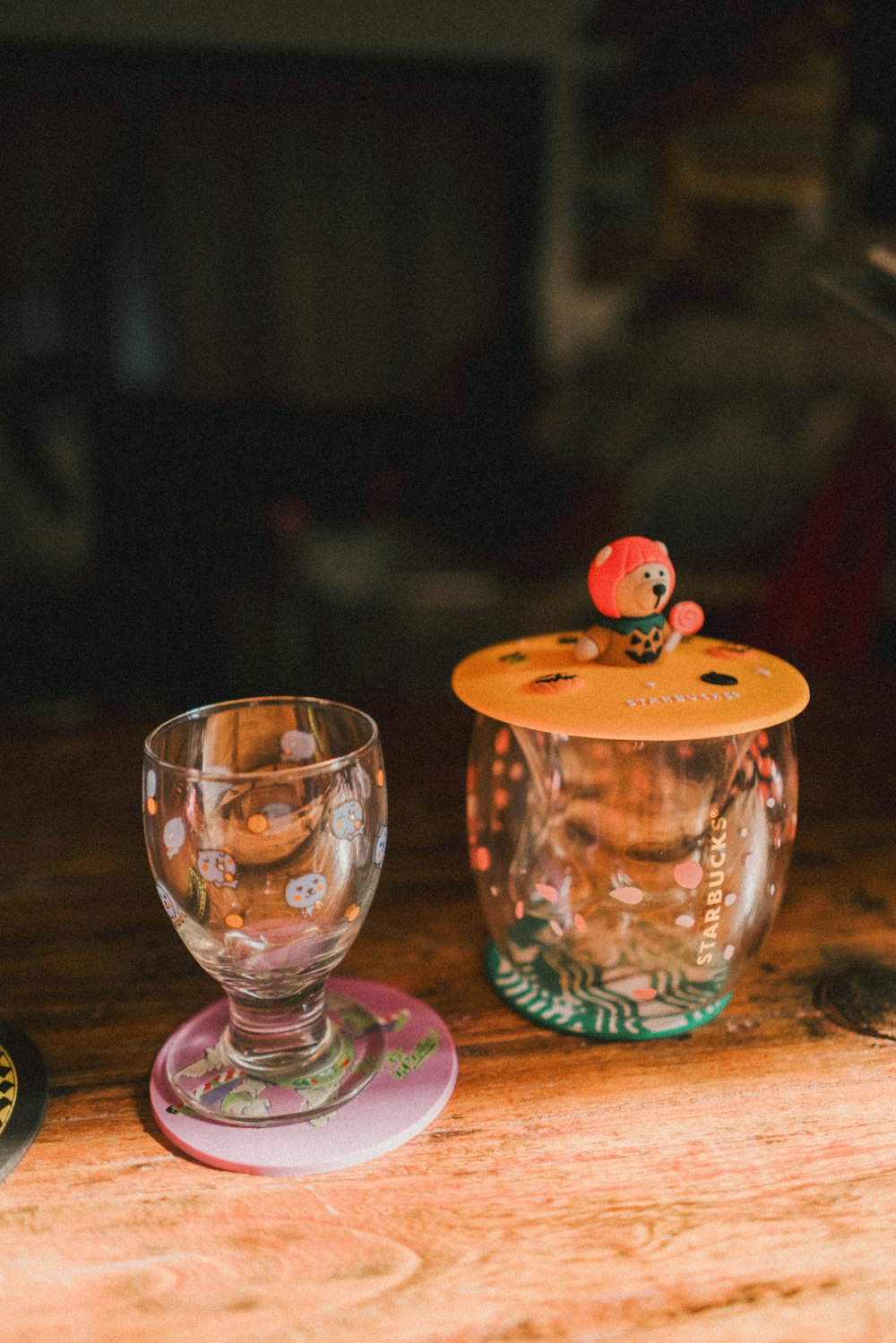 a glass cup and a glass container on a table