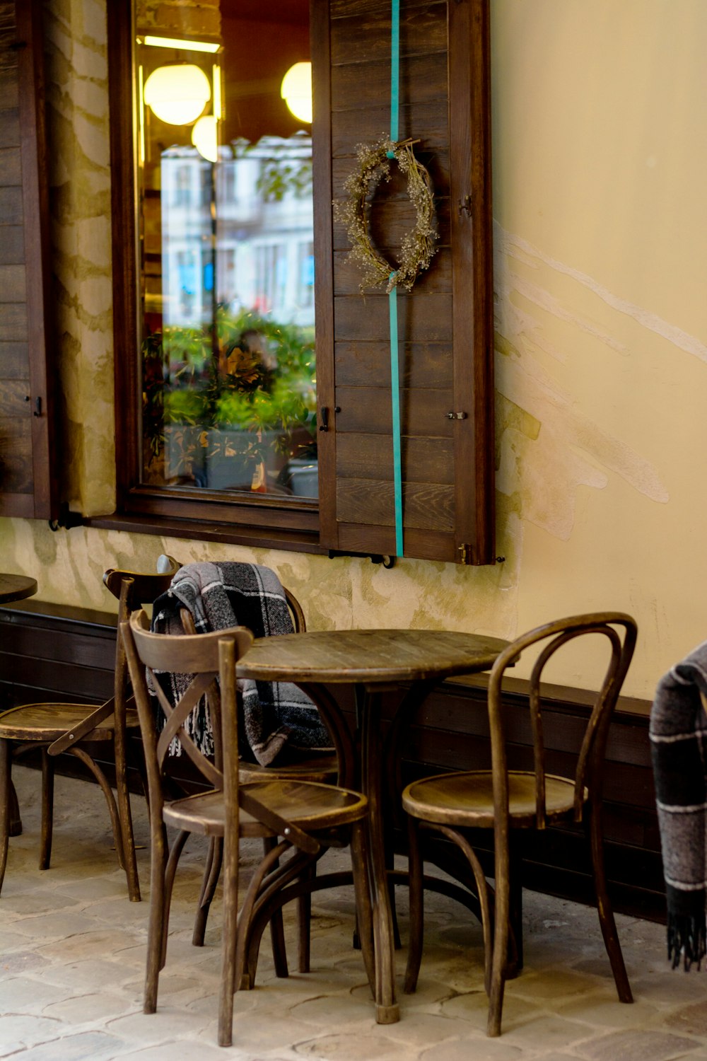 a table and chairs in front of a window