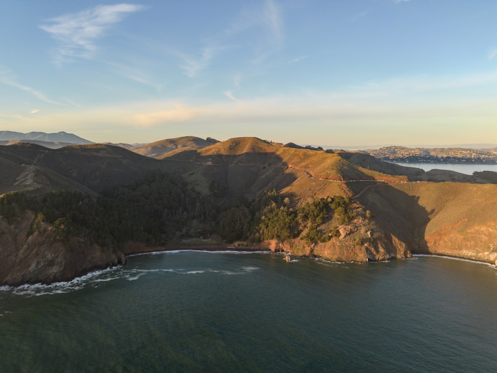 an aerial view of a body of water with mountains in the background