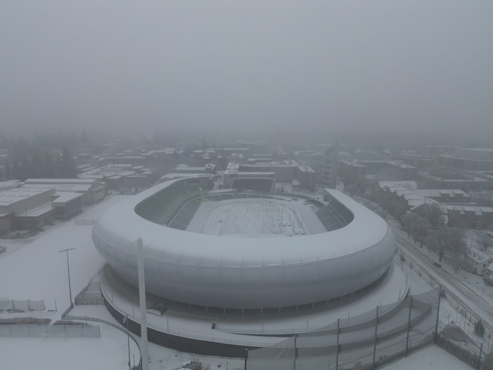 an aerial view of a snow covered stadium