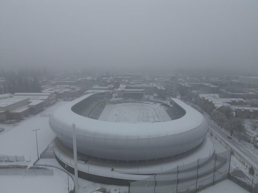 an aerial view of a snow covered stadium