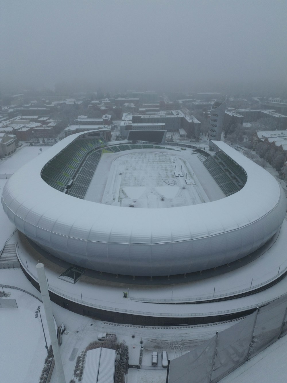an aerial view of a snow covered stadium