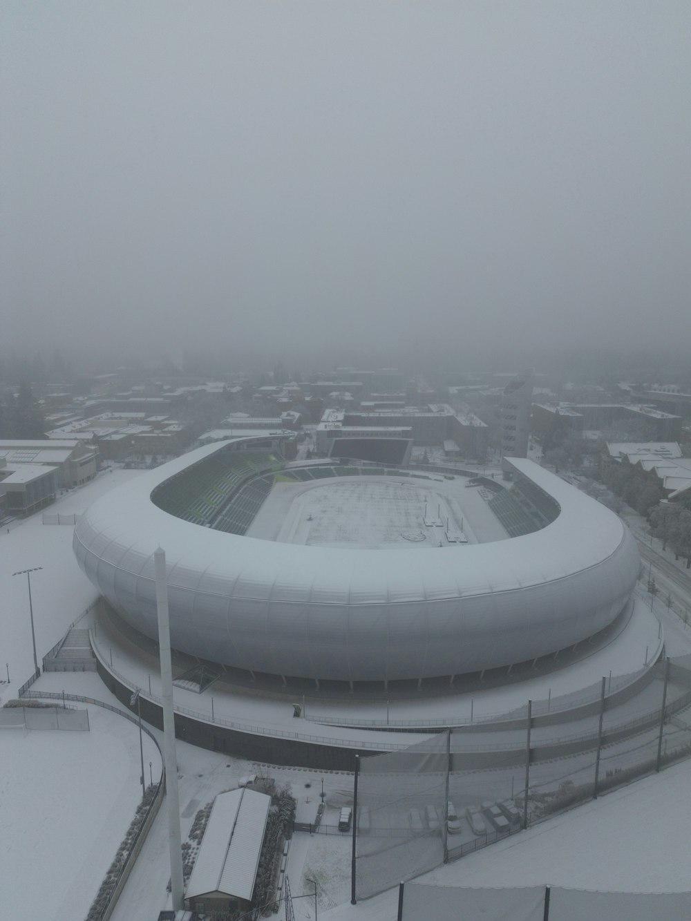 an aerial view of a snow covered stadium