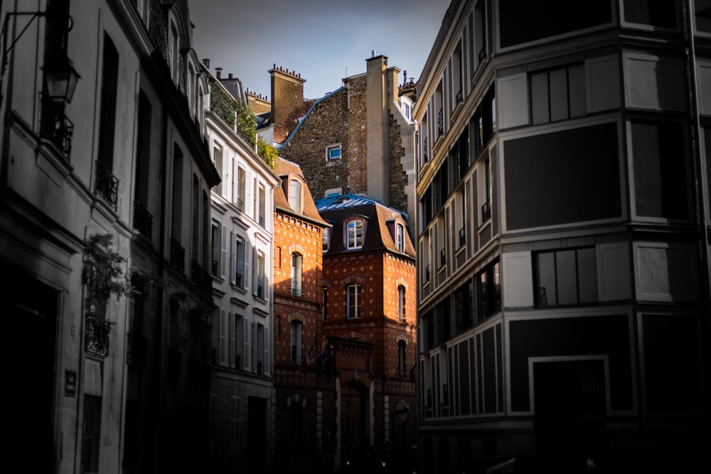 a view of a clock tower from between two buildings