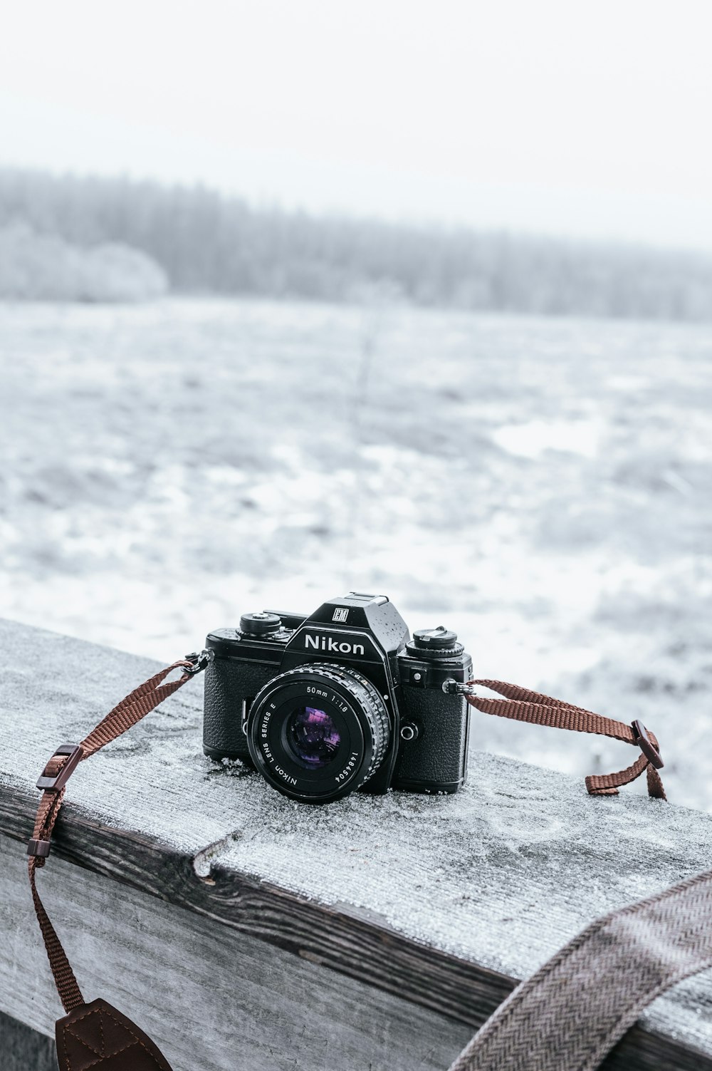 a camera sitting on top of a wooden fence