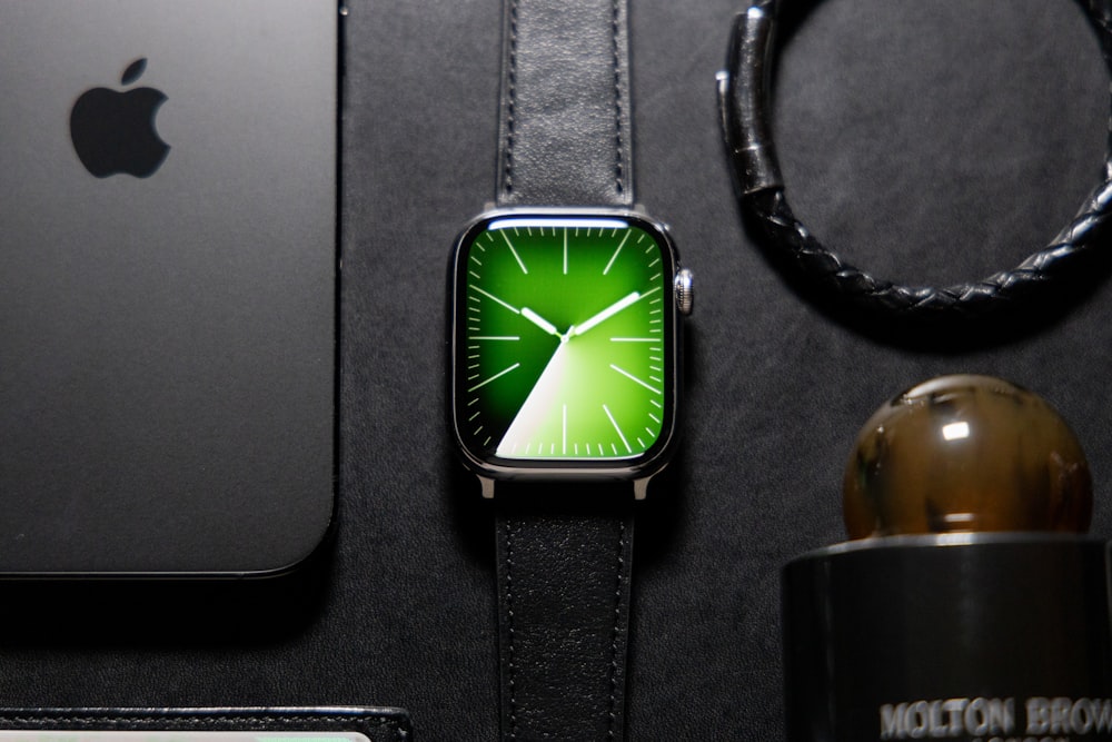 an apple watch sitting on top of a table next to a phone