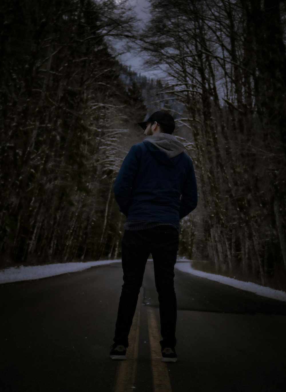 a man standing in the middle of a road