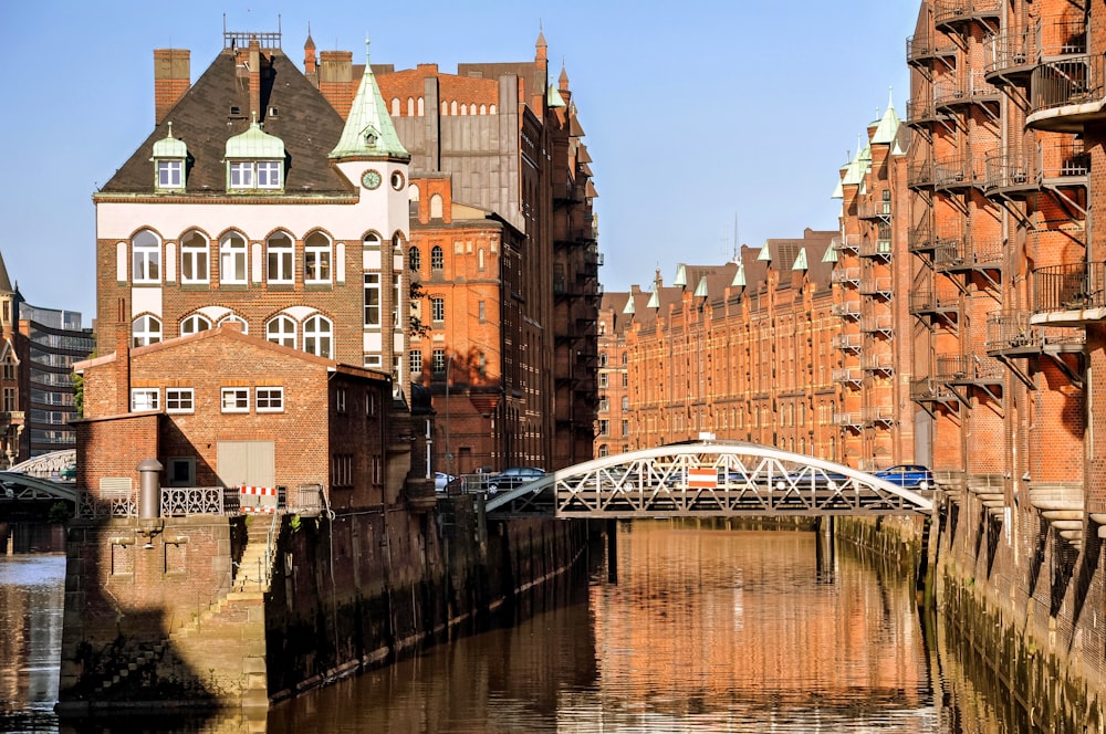 a bridge over a body of water next to tall buildings