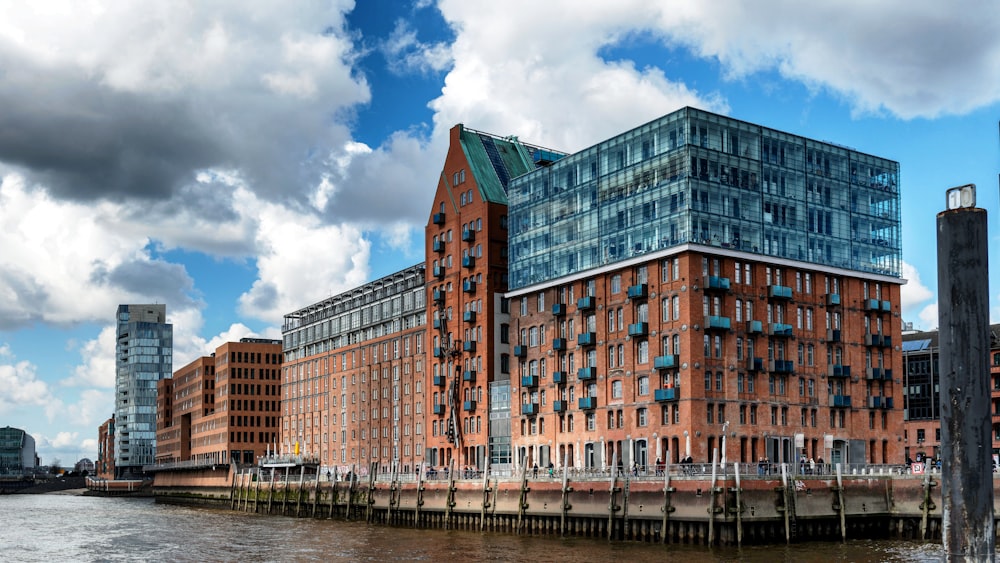 a large brick building next to a body of water