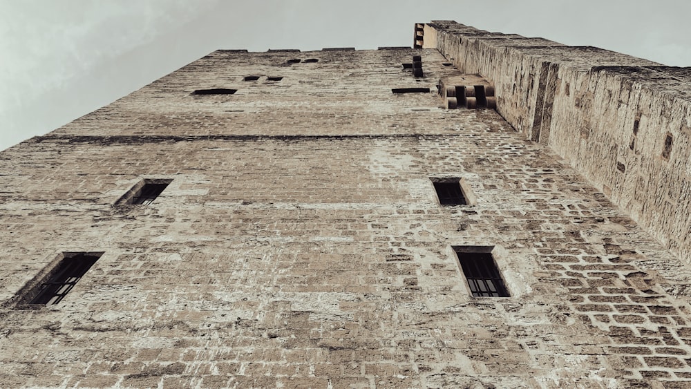 a tall brick building with several windows on the side of it