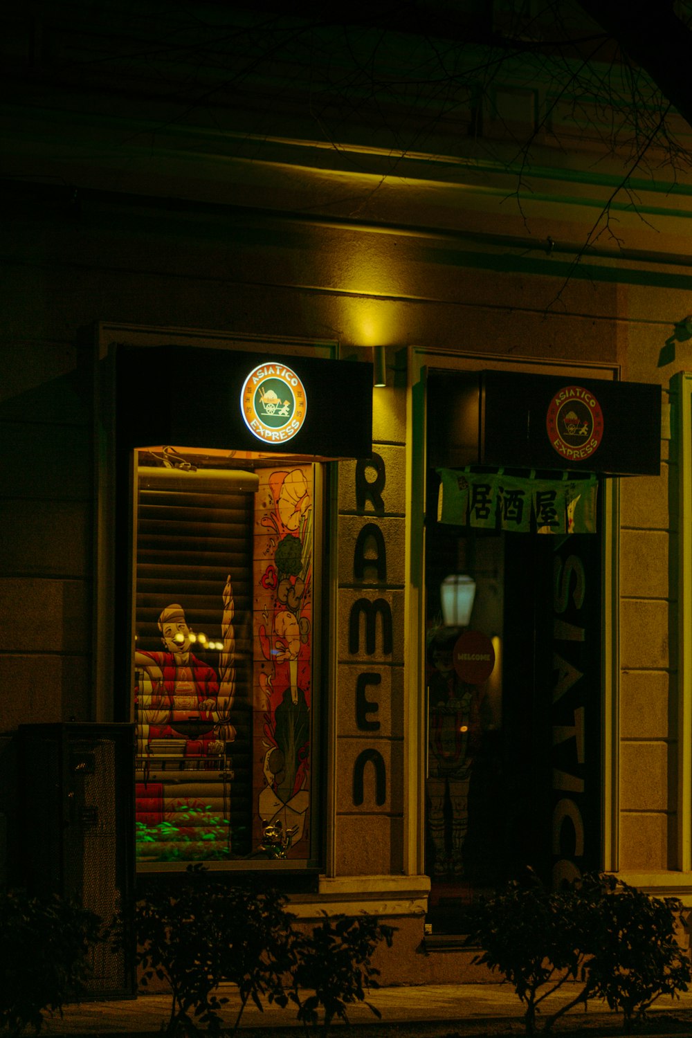 a store front at night with a lit up clock