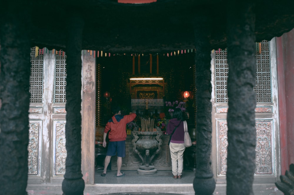 a group of people standing around a fountain