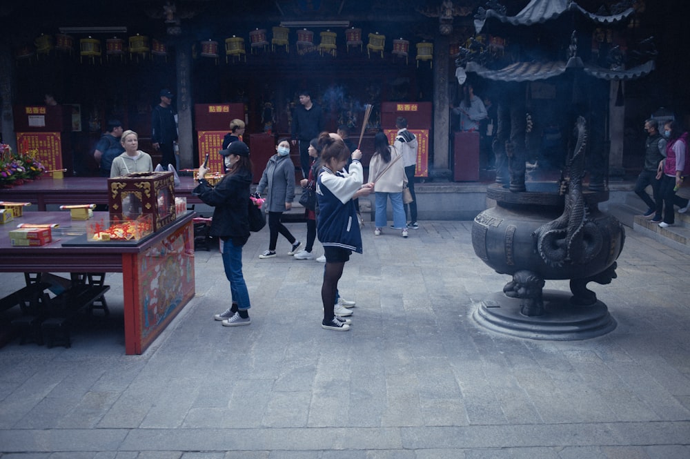 a group of people standing around a building