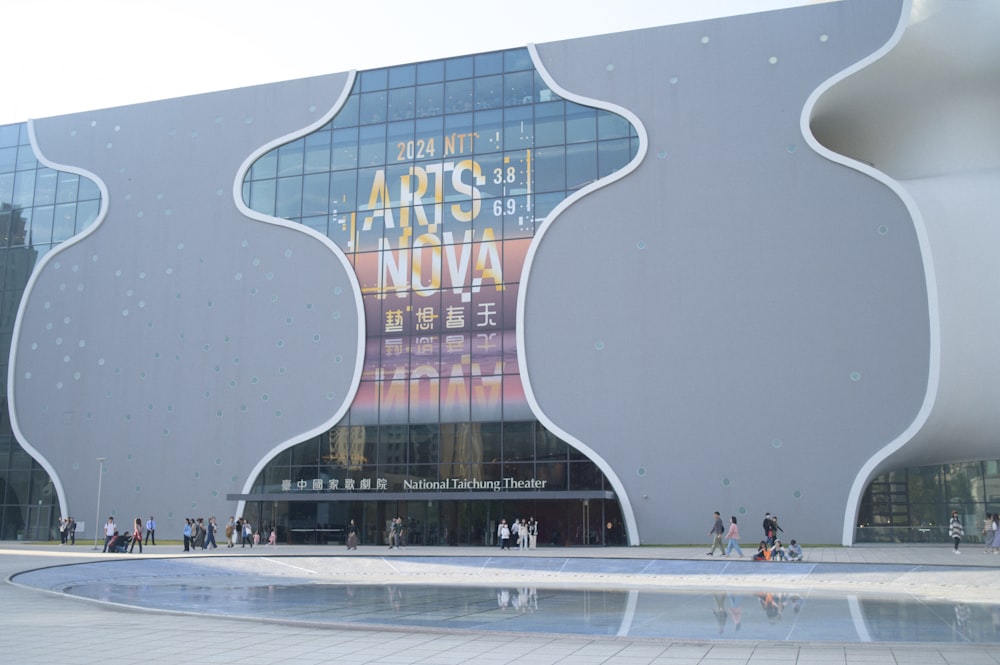 a large building with many windows and a fountain in front of it