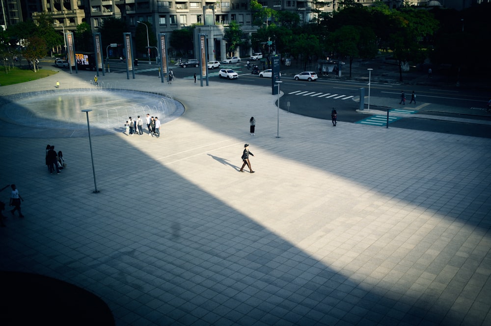 a group of people standing around a fountain