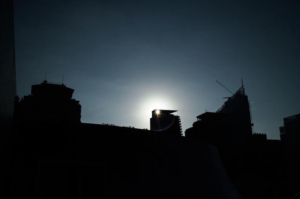 the sun is setting over a city skyline