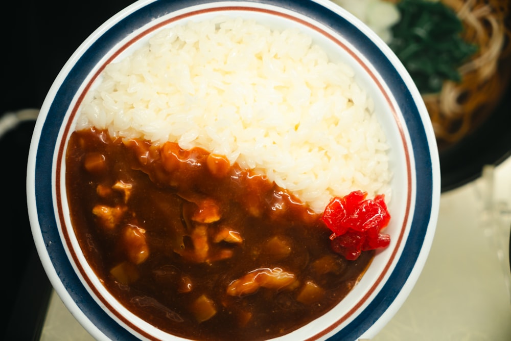 a bowl of rice and a bowl of chili on a table