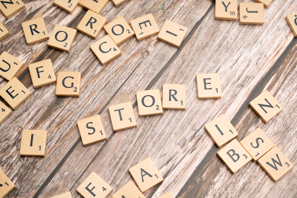 scrabble tiles spelling the word store on a wooden surface