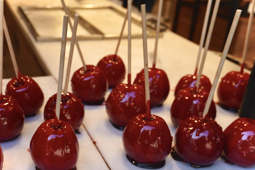 a bunch of candy apples sitting on a table