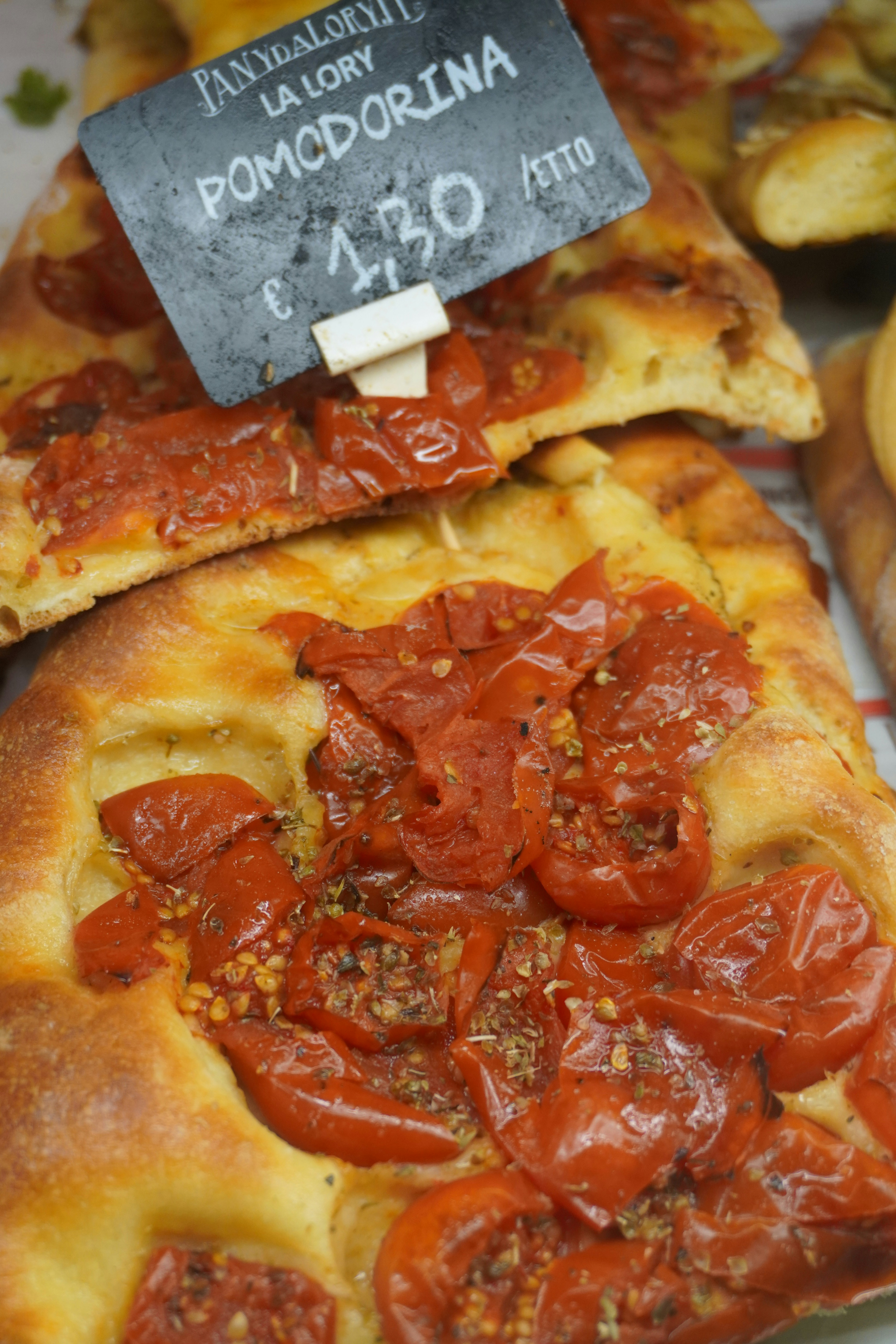 a close up of a pizza with tomatoes on it