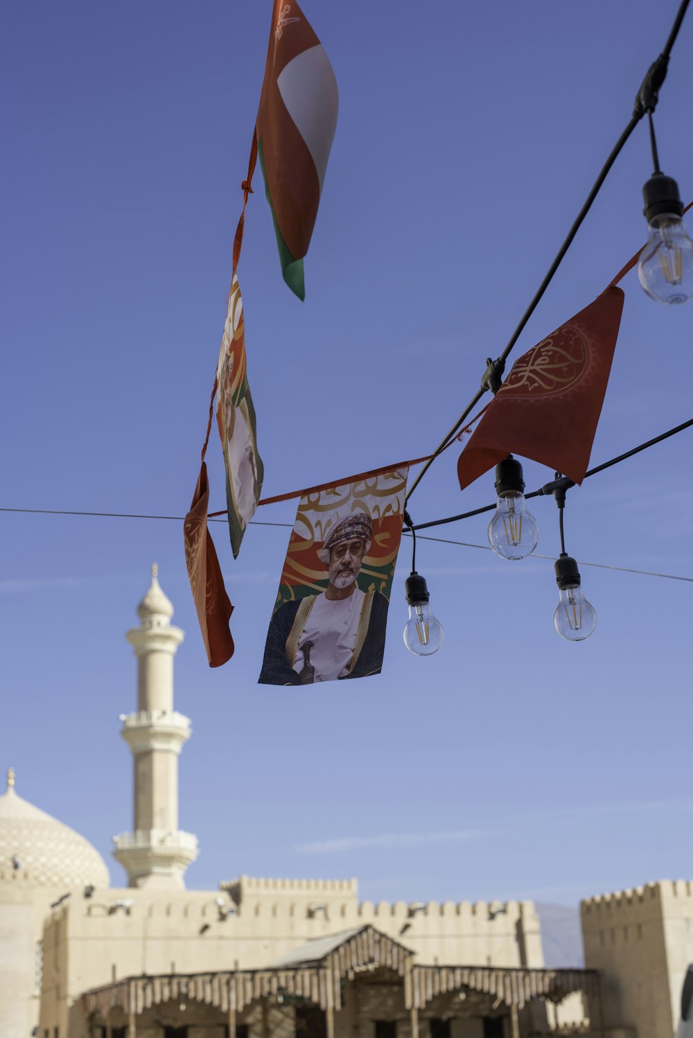 flags hanging from a line in front of a building