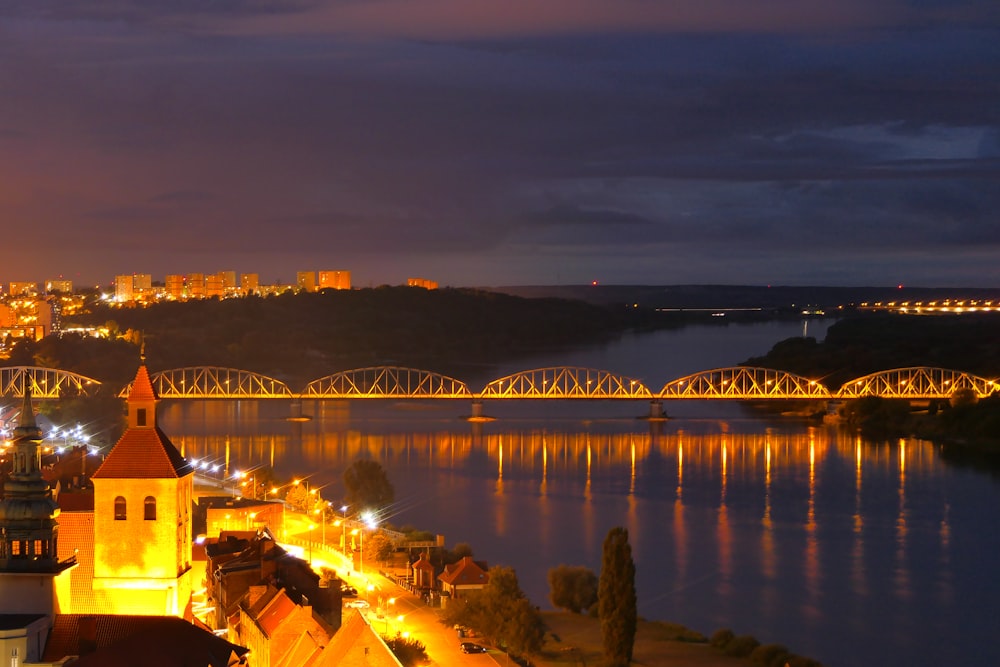 a view of a city at night with a bridge in the background