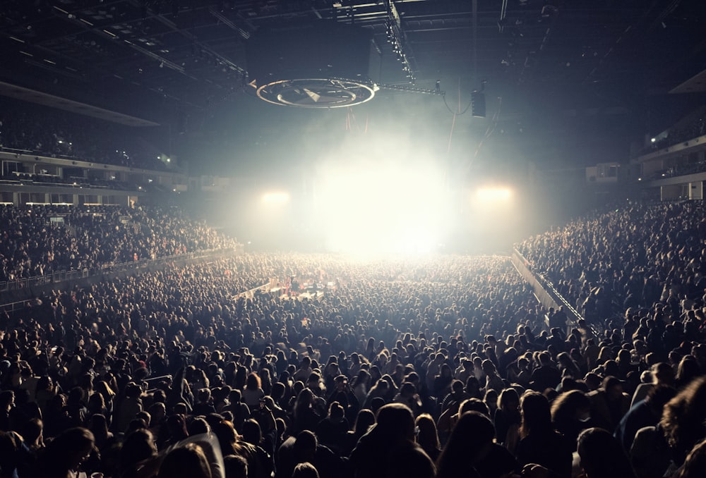 a large crowd of people in a dark auditorium